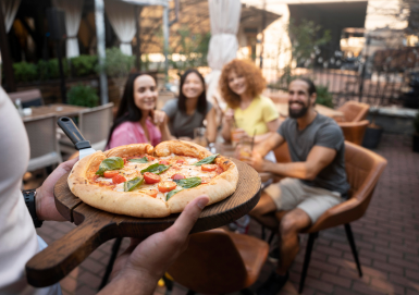 close up friends with delicious pizza in QSR